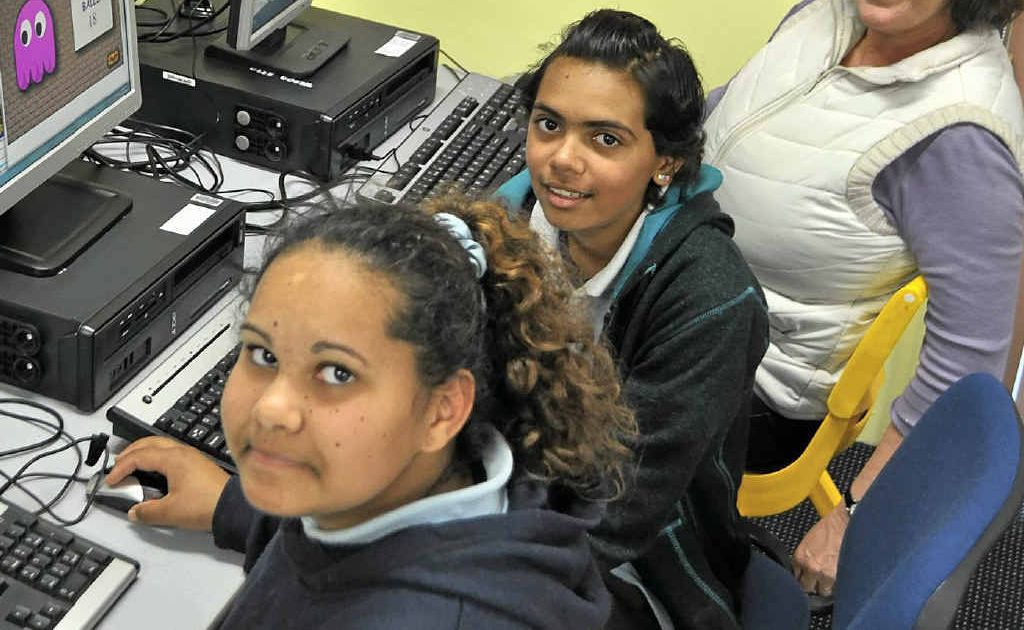 Warwick East students Jessica Lewis, Malikah Woodbridge and indigenous teacher aide Corin Donges working on the ‘Ollie-Up’ learning program.